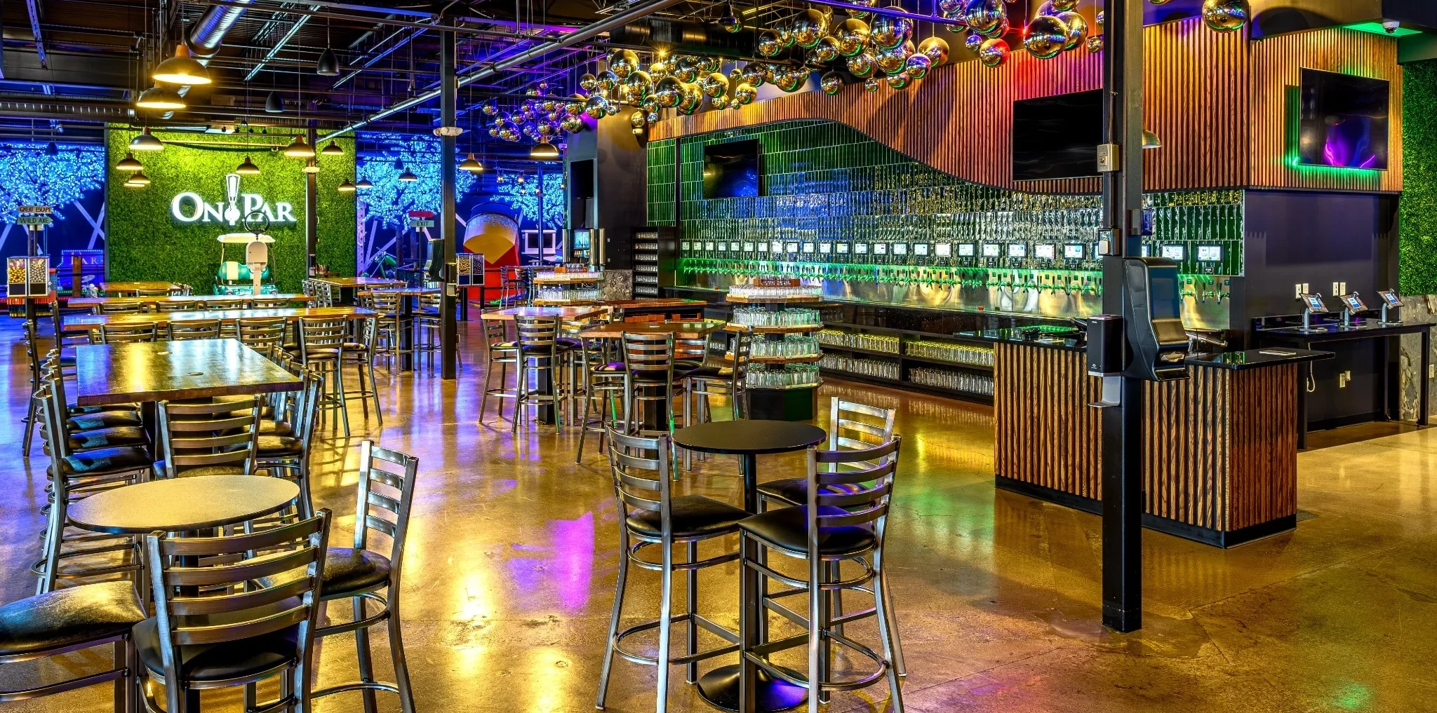 On Par Entertainment’s dining room, colorful disco balls, and self-pour tap wall.